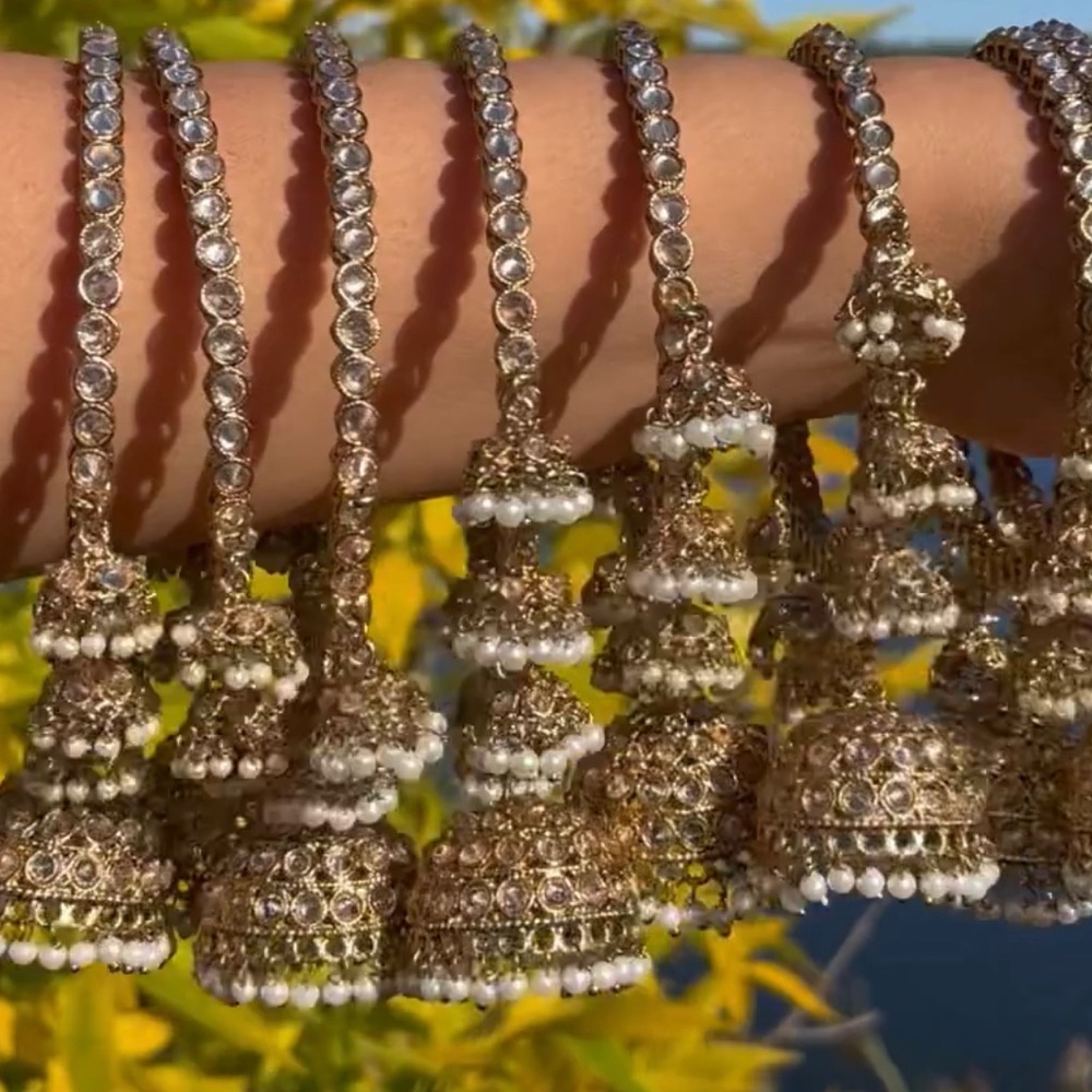 Two bangles in golden colour , kundan style